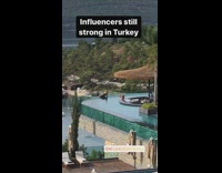 Girl sits poses infinity pool edge turkey 