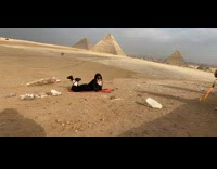 IITW - woman laying on floor pyramids in background