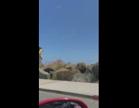 Girl yellow shirt bikini stand rock butt