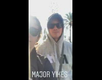 major yikes two girls taking pictures on sidewalk