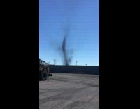 Black dust devil forms at mans workplace 