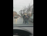 Two guys fight in street block car 