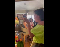 Woman in yellow outfit poses with a ring light