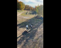 Three men dances near the park table