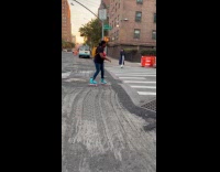 Woman with roller skates cross the road construction