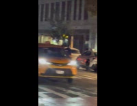 Guy rides bike while carrying a chair