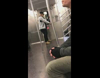 man grey sweater exercise strings on subway