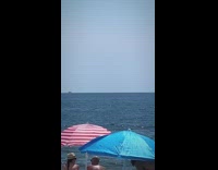 Shark fin seen creeping up above ocean 