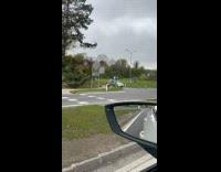 Black and Orange small car seen on the highway 