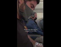 Couple hold hands on plane after getting engaged 