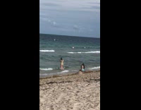 Woman green bikini walk towards beach pictorial