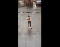 Guy shirtless black pants dance outside parking