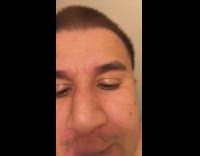 Guy gives himself a haircut in bathroom and checks himself out in mirror and selfie  camera