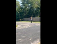 Woman tube top skirt poses on onewheel
