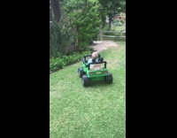 Little kid drives green battery powered car into garden wall