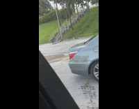 Green shorts girl exercises black rope tripod 