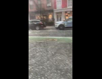 Rain hails near NYPD car 
