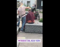 Pink shirt lady gives guy haircut outside 