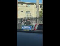 Guy dances on sidewalk with earphones 