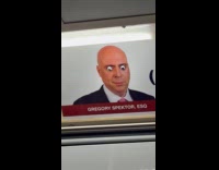 Googly eyes placed on Attorney poster in train