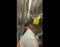 Drunk couple in white stand in train 