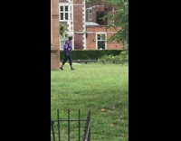 Purple jacket guy leans against arch tripod 