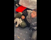 Kid struggles to stay awake while watching tv