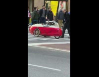 small red white three wheel car street 