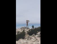 Shirtless man hold up wood pictorial rocks