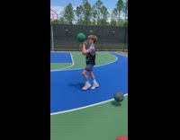 Guy dribbling basketballs while balancing on basketballs