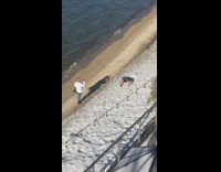 Guy black pants pushup  and headstand beach part 1