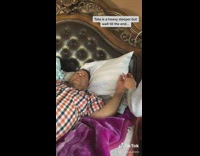 Girl pranks sleeping dad orange black plaid 