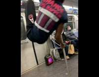 Man in spider man mask hang on railings subway