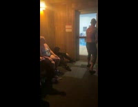 Guy rapping in corner of room while other guy boxes