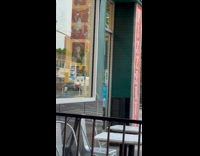 Collab WINY - Man  black shirt carry stacks of pizza boxes into store