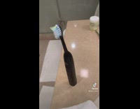 Electric black toothbrush moving around on counter