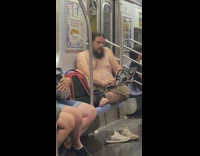 Shirtless guy with laptop in train 
