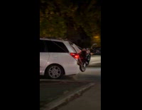 Collab WINY - Scooter tied at the back of van