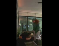 Two girls pretending to fight in living room