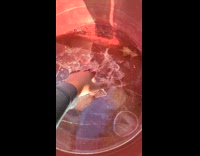 Man drops ice frozen from water basin