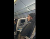 Guy and baby staring on plane