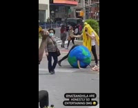 Person in Globe Costume Twerks with Rapping Banana