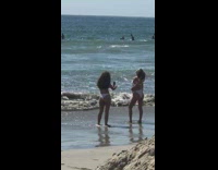 Two women white bikini beach water sand