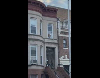 Skeleton hangs from window