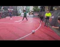 Guy kicks soccer ball straight into guys back 