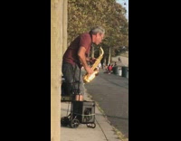 Red shirt guy plays saxophone river bridge 