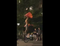 Man rides on high chair bicycle exhibition at the park 