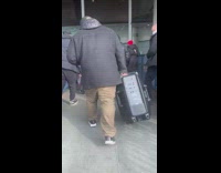 Guy carrying large portable speaker blasts music 