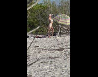 Woman in bikini caught the filmer at the beach