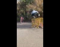 guy denim jacket jumps over yellow gates